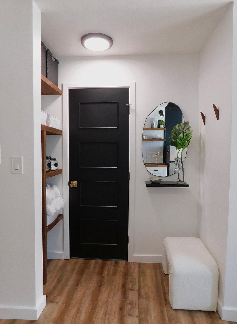 Another view of the entry nook, there is a cream-colored boucle ottoman in the nook where you can sit and put on or take off your shoes :-) There's also an outlet in the corner for your convenience.