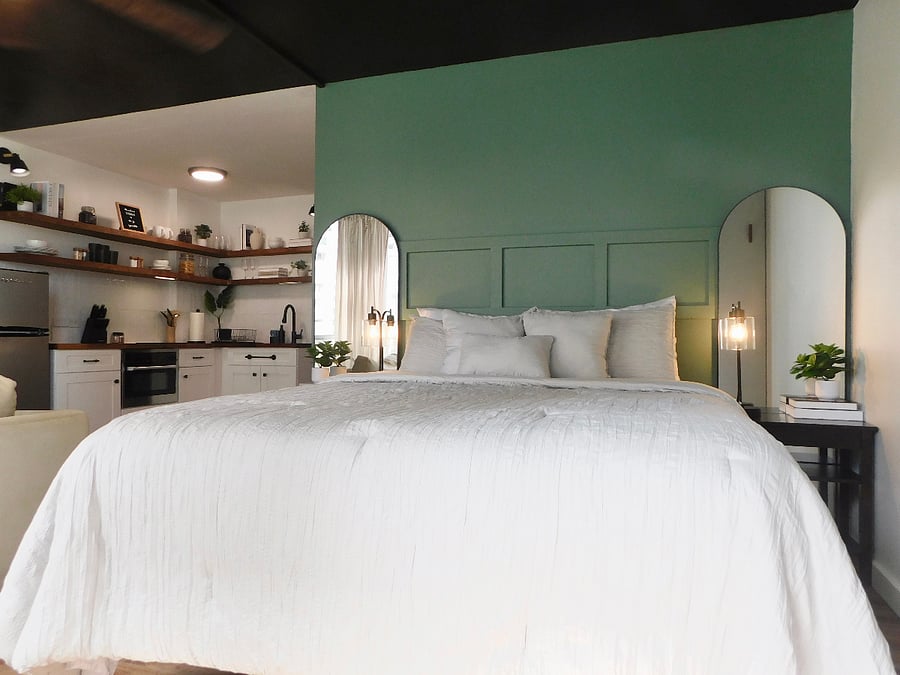 Cozy queen-sized bed with plenty of pillows