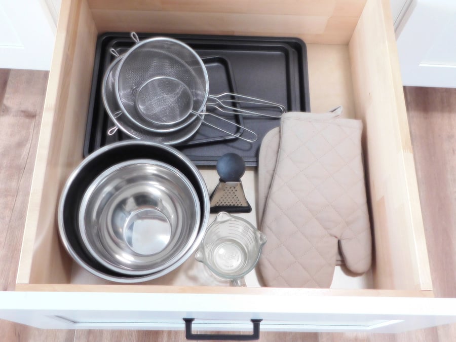 Baking sheets, strainers, mixing bowls, measuring cup, grater and oven mitts and pot holders