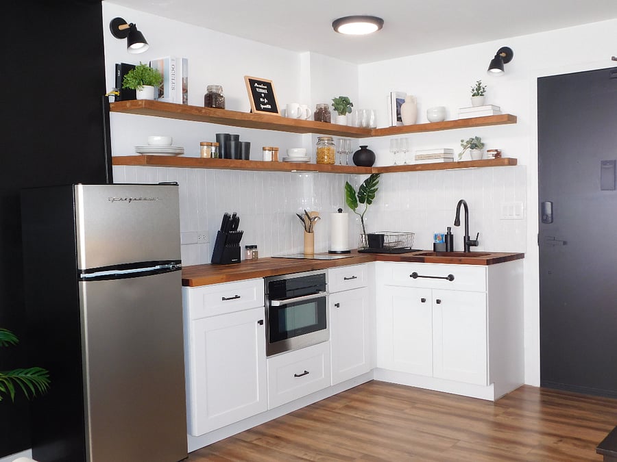 Midsize fridge and freezer. Lots of counter space, 2 burner induction stove top built into counter, built in microwave/convection oven combo, floating shelves to store all the dishware