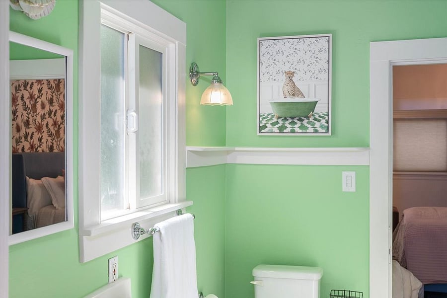 Jack and Jill bathroom with a tub, she's been painted "green with jealousy".