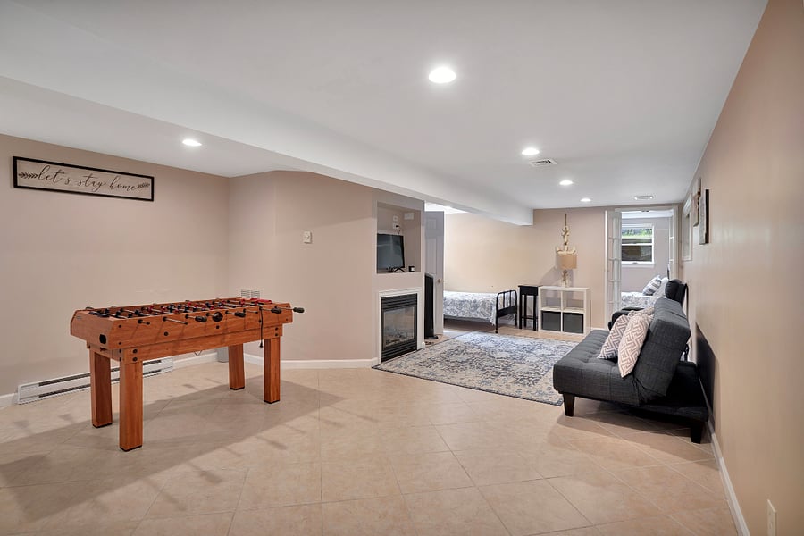 Spacious area with foosball, TV, fireplace, sofabed, and a twin bed