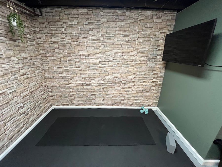 Yoga/workout area with Smart TV in laundry room.