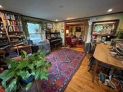 One of two living rooms featuring a piano!