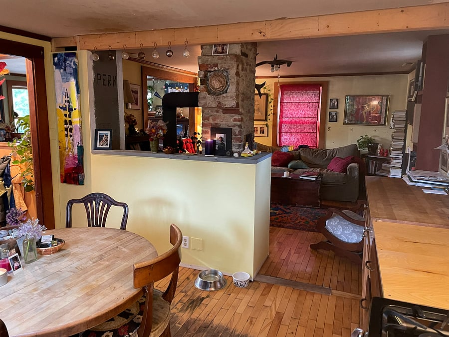 Kitchen with view into living room with woodstove.