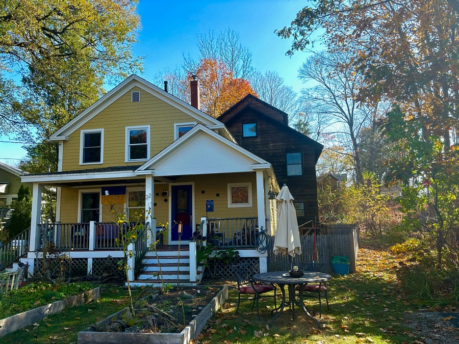 Exterior view showcasing large wood front porch.