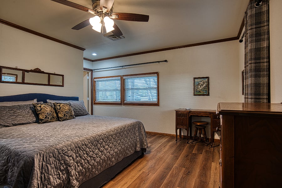 Primary bedroom with king size bed located off mudroom at backdoor.