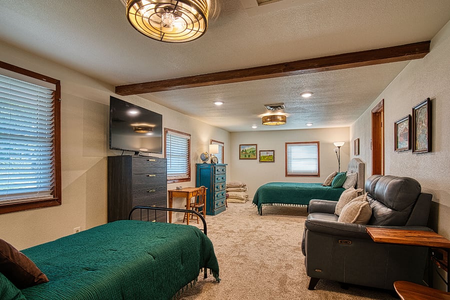 Second bedroom with queen size and twin beds. En-suite bath with shower and over-sized walk-in closet.