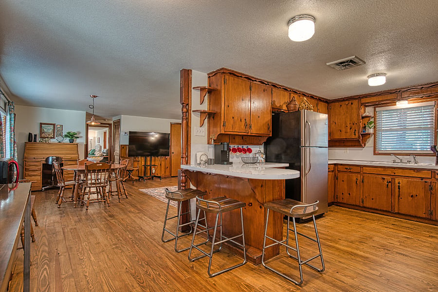 View of kitchen, breakfast bar, breakfast table to dining