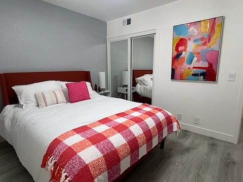 This well lit and spacious guest room offers a comfortable queen size bed with extra padding and generous hanging closet space with nitch spaces as well as a large bedroom dresser.