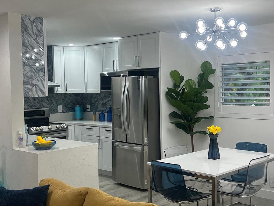 This chef's kitchen offers a hooded range with a double-oven, hands free faucet, silent mode garbage dispenser, numerous cabinets for your treats and a curate selection of fine china and everyday dishware including children's dishes as well as glassware (coffee mugs, wine glasses and children's cups).