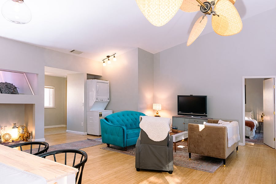 spacious interior with dining room table that seats 6, living room, washer/dryer, patio