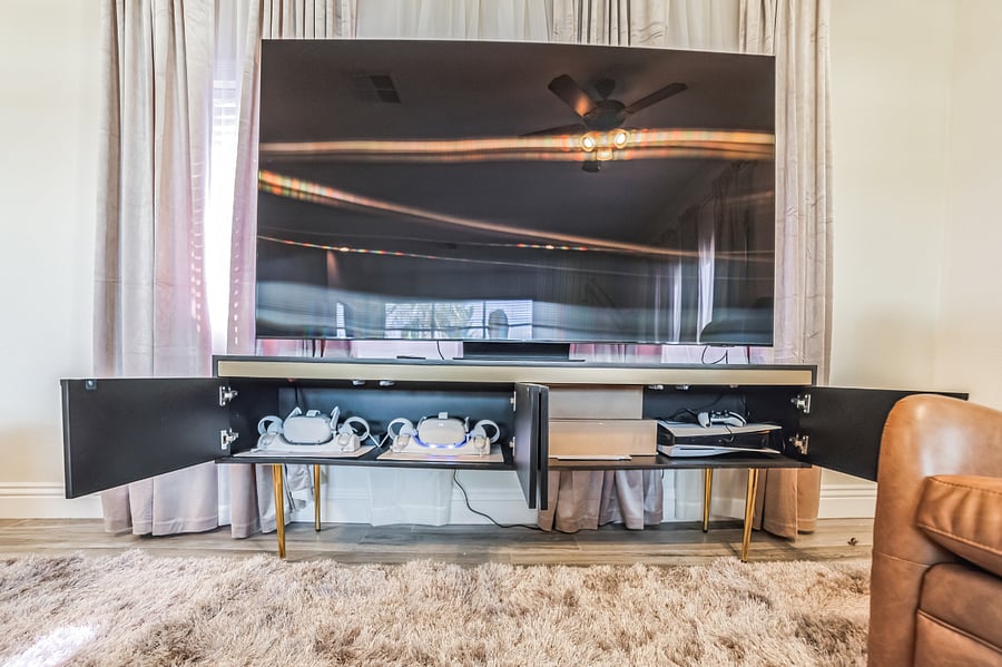 Main house recreation room with 85" OLED TV, Play Station 5, and two Meta Oculus Virtual Reality systems