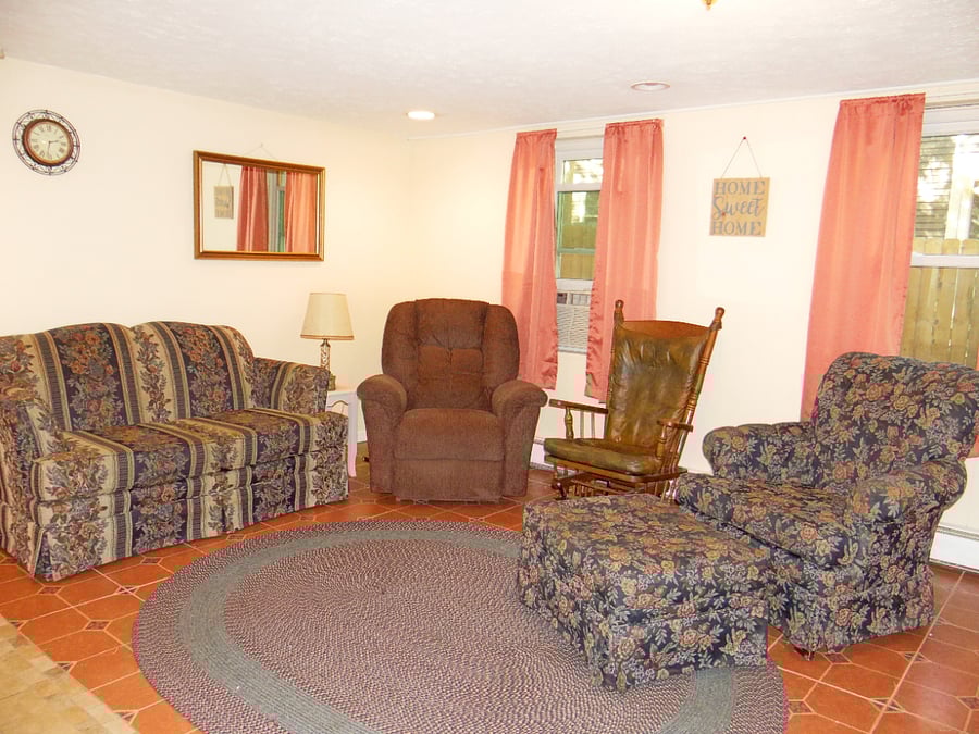 Lower level, cozy living area. Sofa, recliner, easy chair, rocker and Smart TV.
