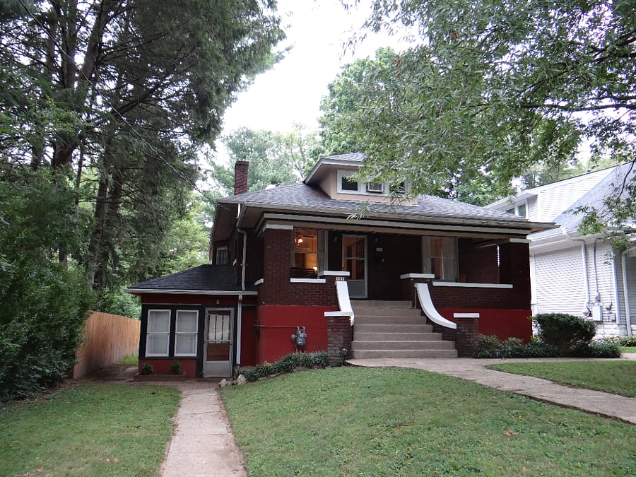 Entrance to the lower-level unit is to the left of the home