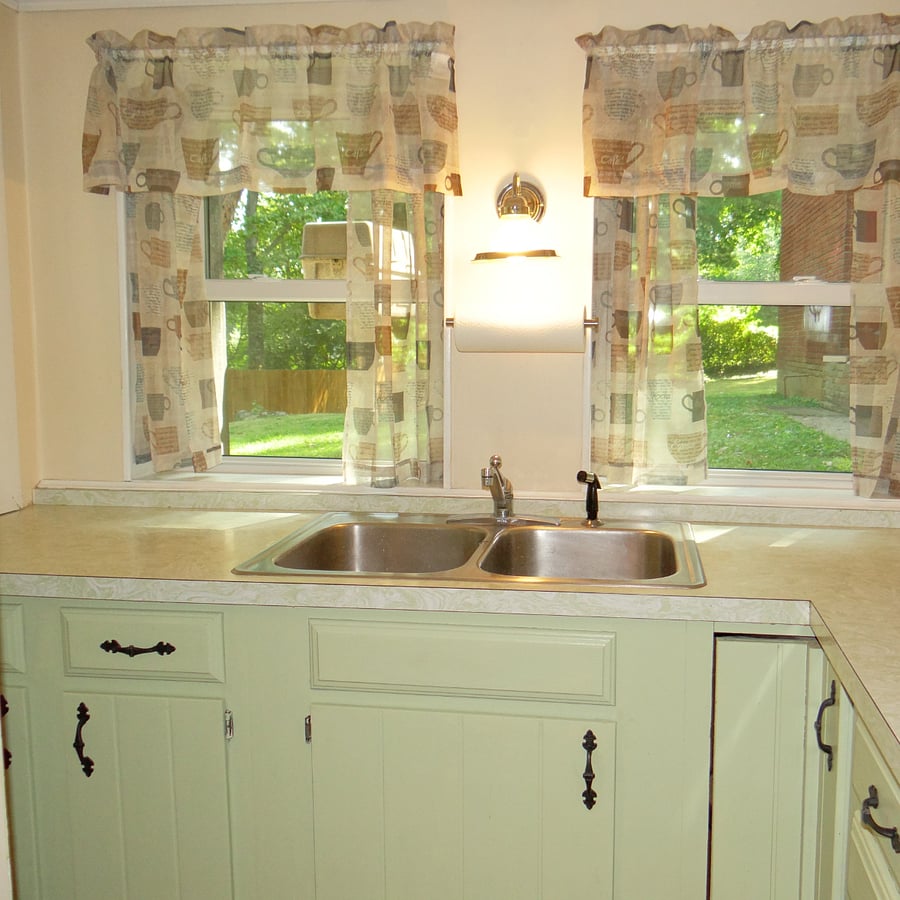 Galley style kitchen overlooks backyard