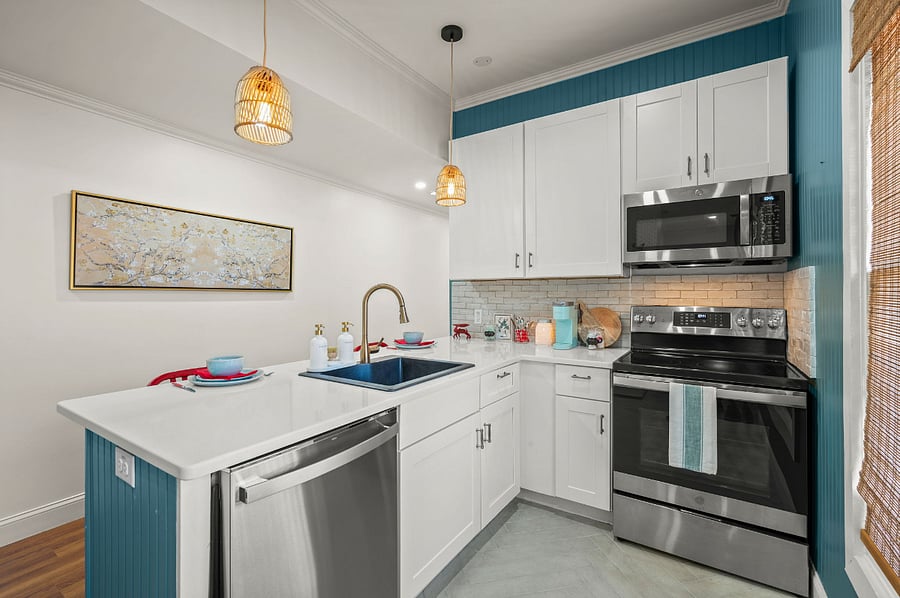 Fully stocked kitchen with dishes, glasses, pots and pans, utensils, Keurig, blender and washer/dryer.