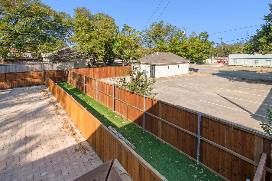 Fully fenced in dog run with astroturf and running water.