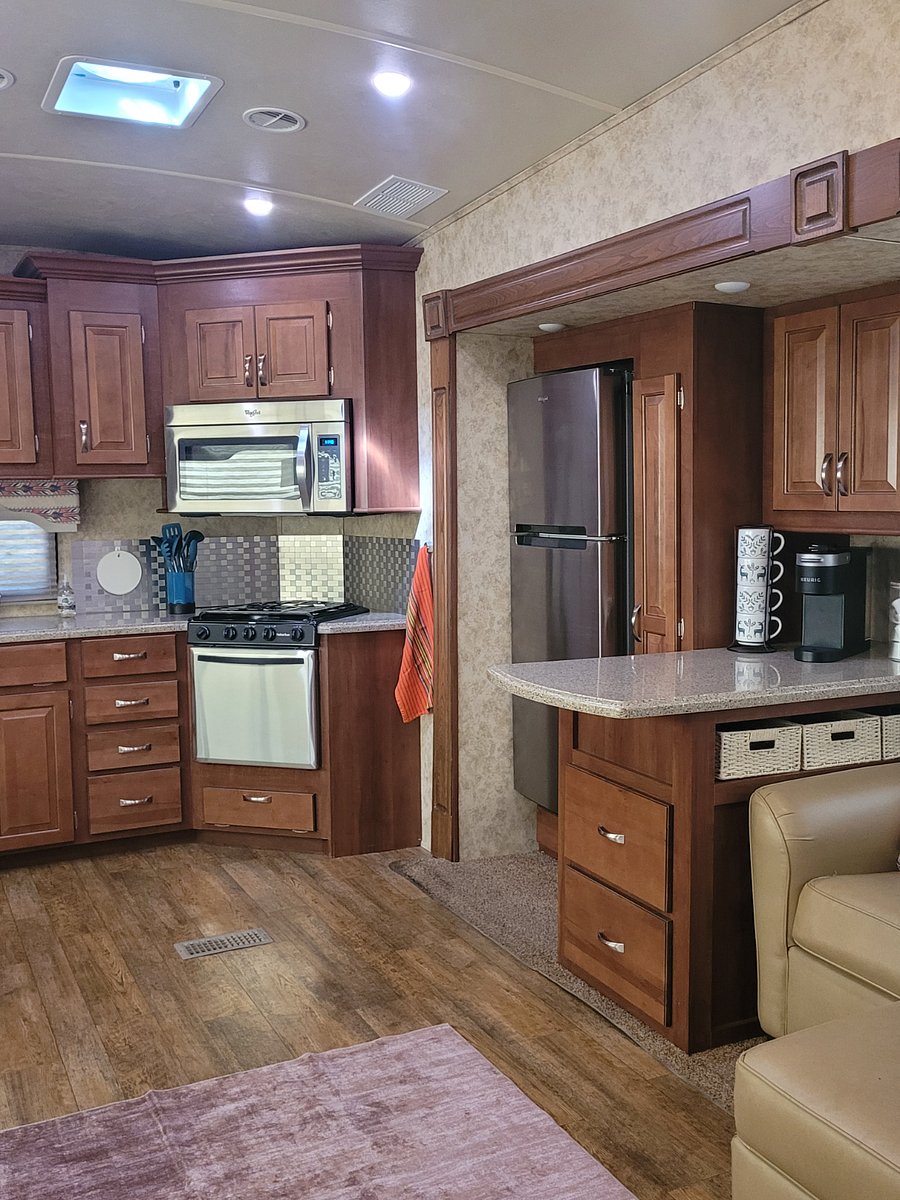 Propane gas stove and oven, apartment sized fridge, slide out pantry, coffee bar counter area