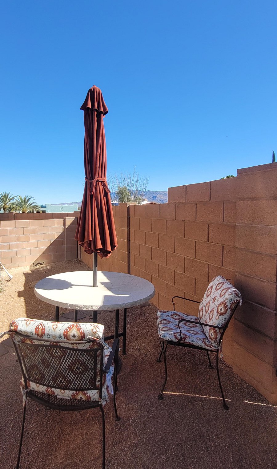 Outdoor dining table, chairs, and umbrella.