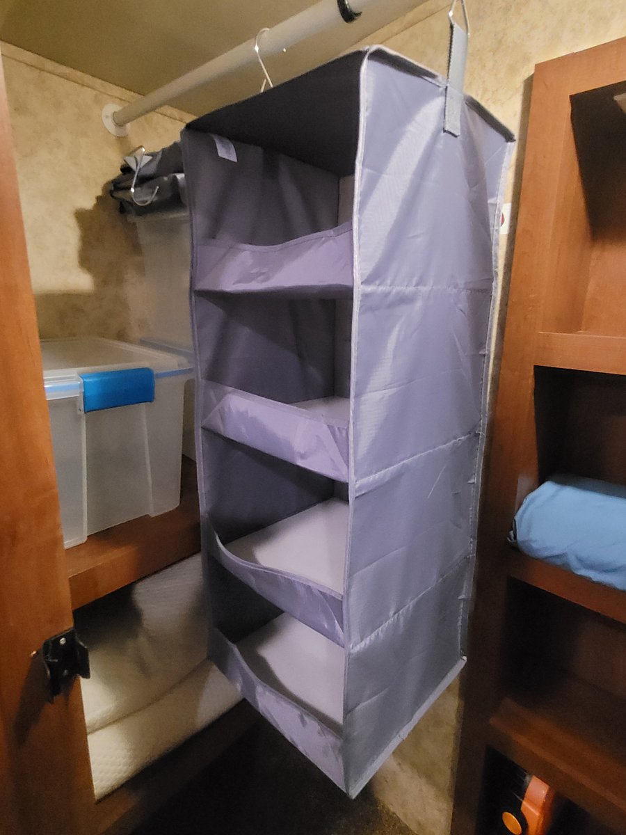 Shelves in closet. Storage bins. Extra pillows. Hanging bins.