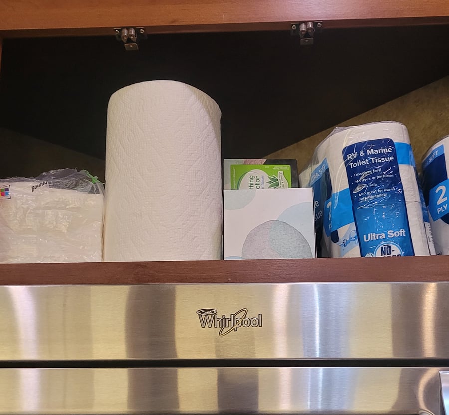 Paper products in cabinet above the stove.
Napkins, paper towels, facial tissue, and RV toilet paper.
