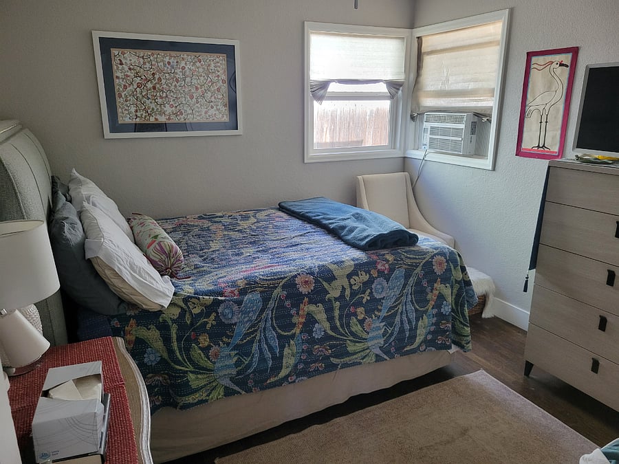 Bedroom with queen size bed, dresser, end table and TV. Ceiling fan and a/c.