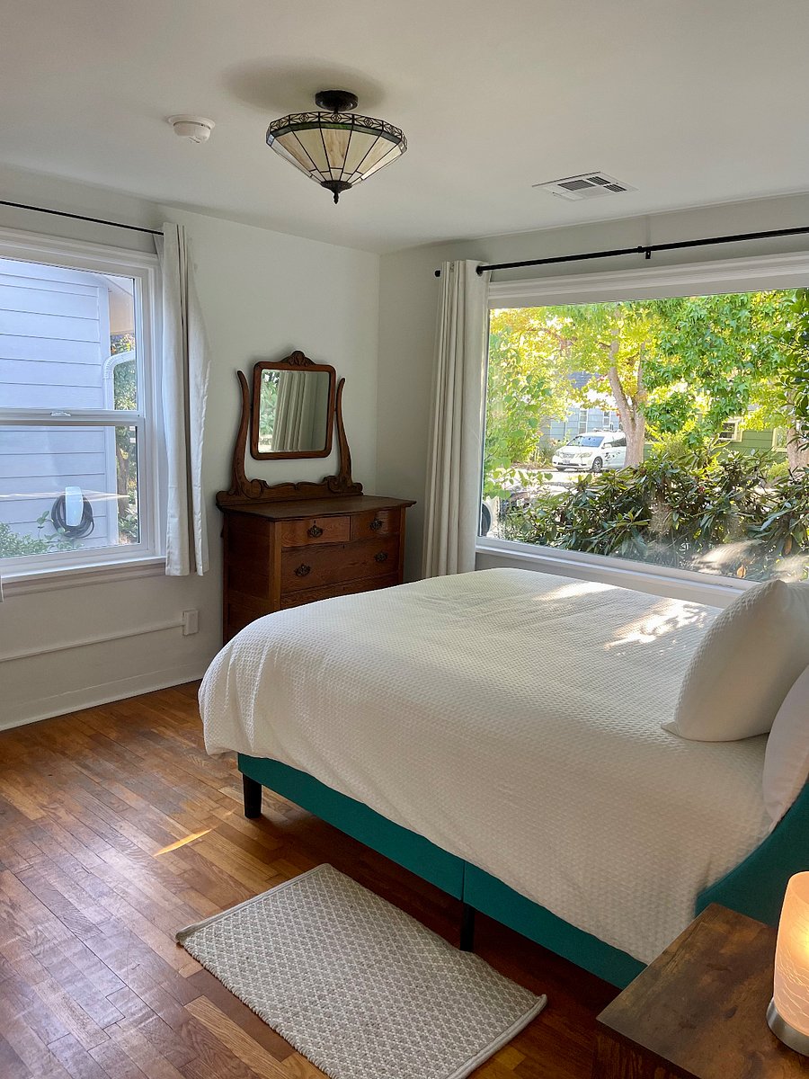 Primary bedroom with a queen bed, two new closets, built in drawers, and a vanity