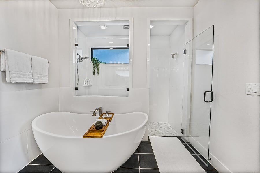 Bathroom #1: Primary Bathroom with large walk in shower, a soaking tub and large vanity with two sinks.