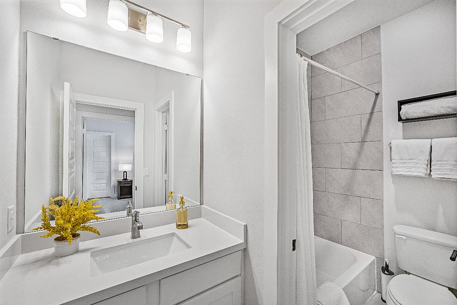 Bathroom #3: Upstairs bathroom vanity accessible to upstairs common areas that leads to a shared shower/toilet.