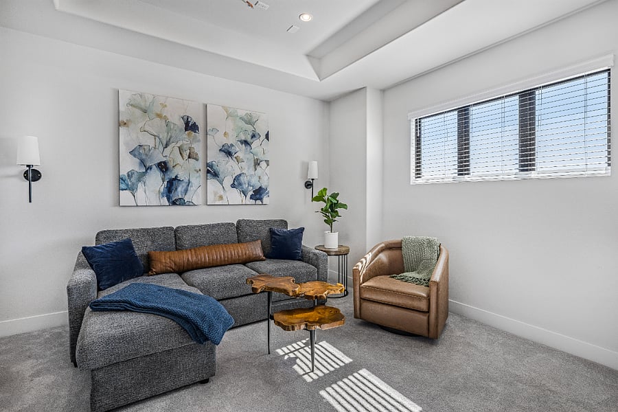 Upstairs TV room with 70" smart TV and sleeper sofa.