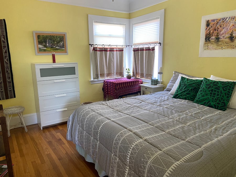 The bedroom in the back of the flat, away from the street, features a king bed.
