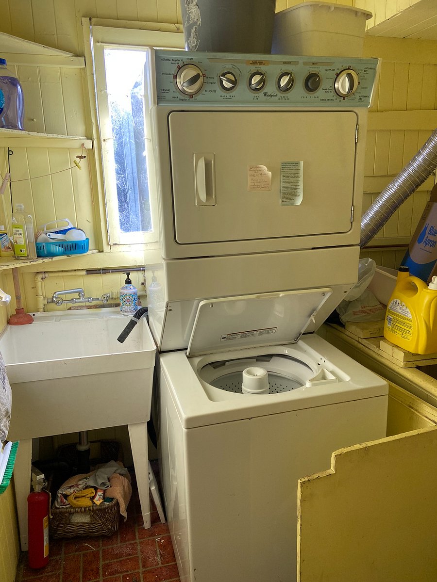 The laundry room is just off the kitchen and has the stairs down to the back yard.