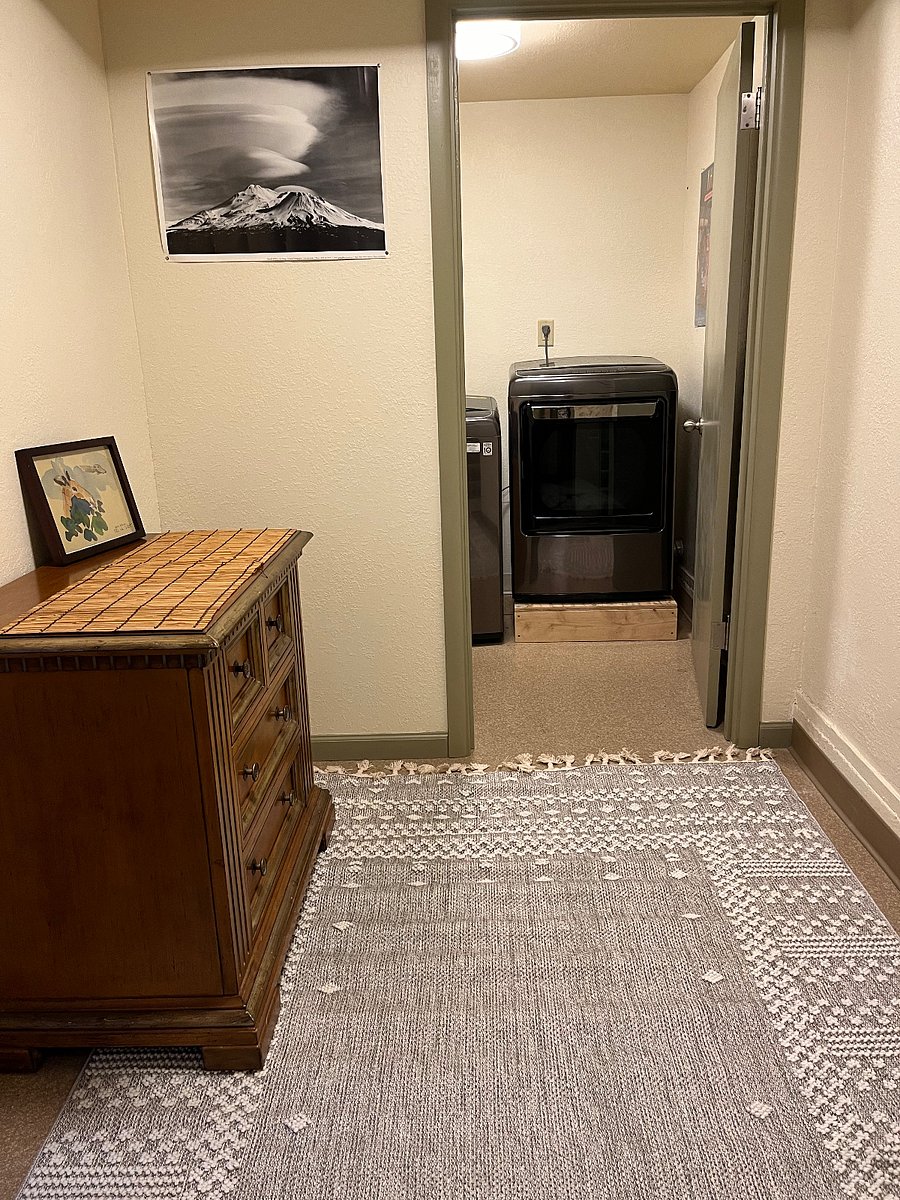 Foyer with dresser and access to private washer and dryer.
