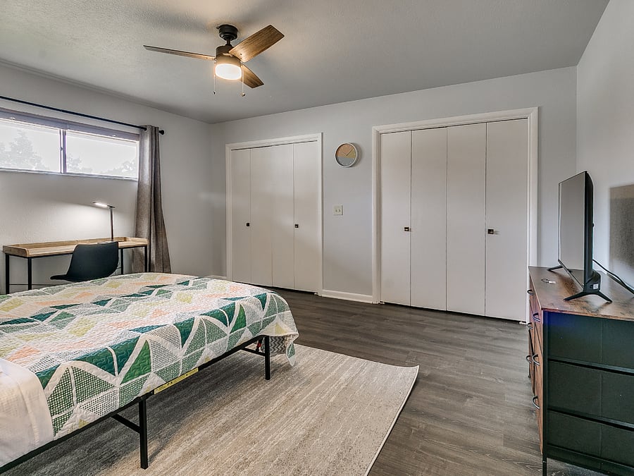 Bedroom #2 with private hallway bathroom, double closet, and office desk/chair.
