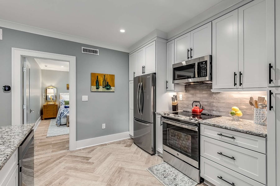 Kitchen with full fridge, range, and microwave