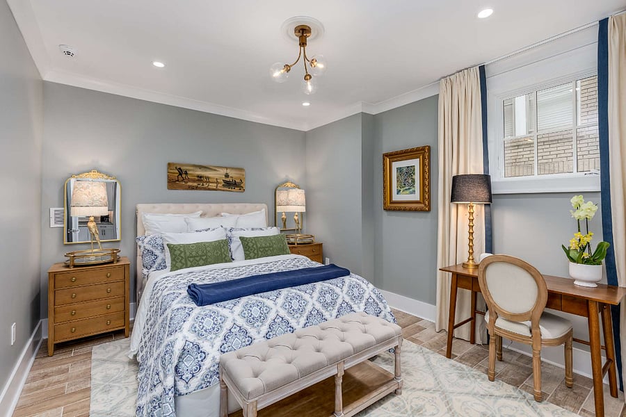 Primary bedroom with queen-sized bed, work desk & chair, and large closet with hangers for clothes and space for storage. Night stands have three drawers for storage well. Extra pillows and blankets provided.