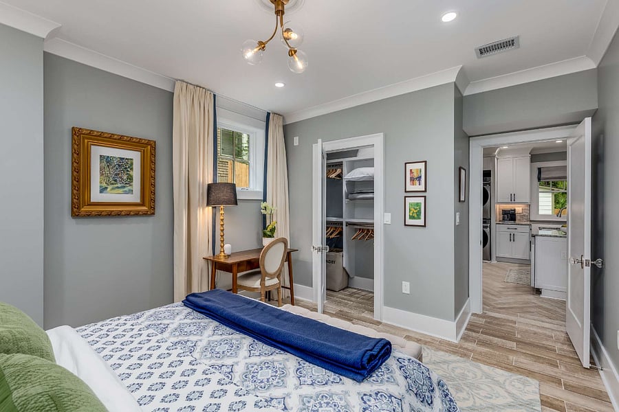 Primary bedroom with queen-sized bed, work desk & chair, and large closet with hangers for clothes and space for storage. Night stands have three drawers for storage well. Extra pillows and blankets provided.