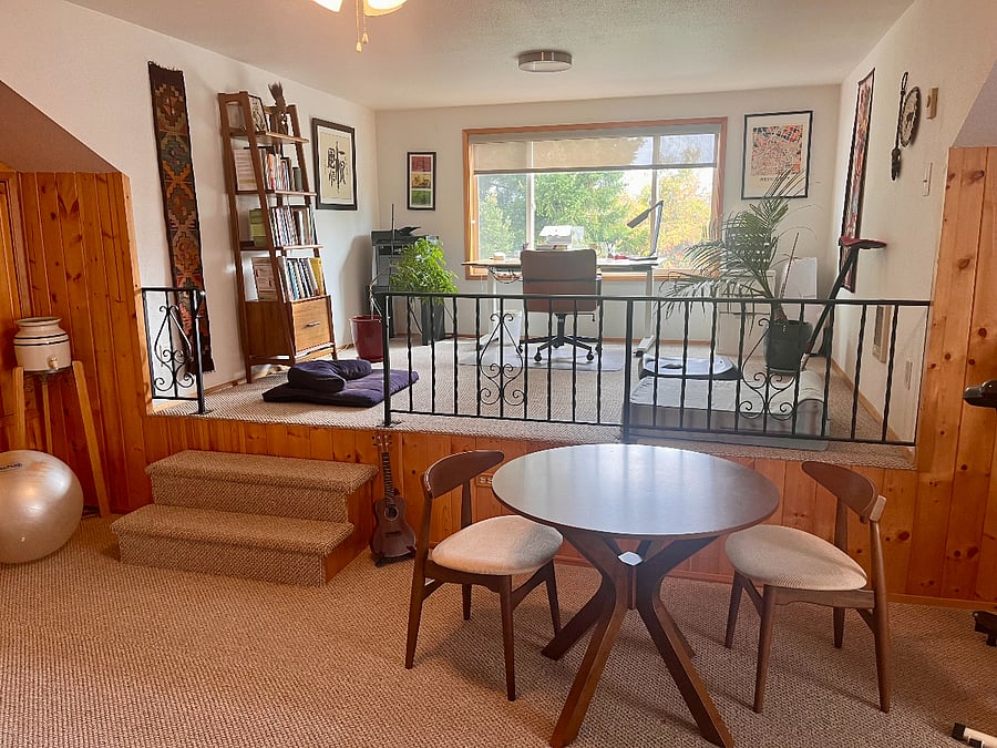 Upstairs loft area with TV, recliner, bean bag lounger, eating area, Fit Desk exercise bike, & office area.
