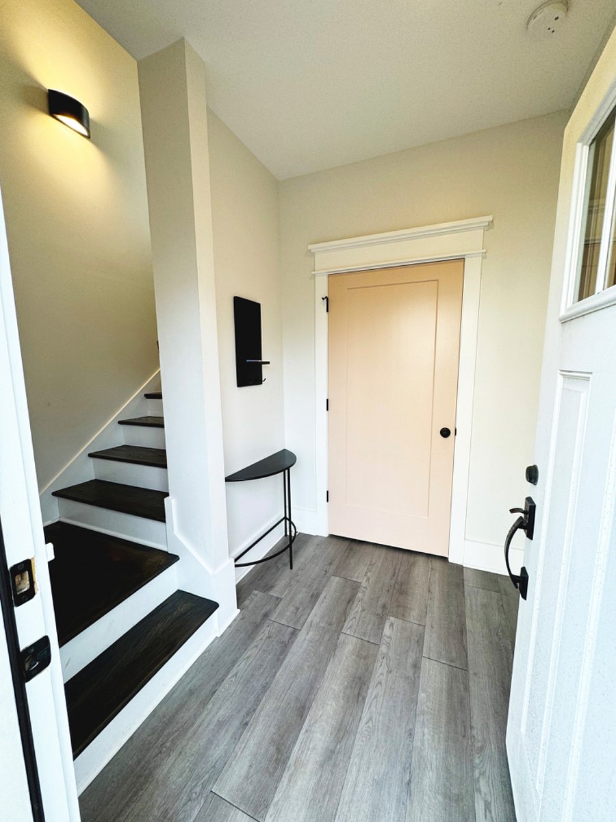 Ground floor entrance with washer & dryer behind the door. Stairs lead up to main living area.