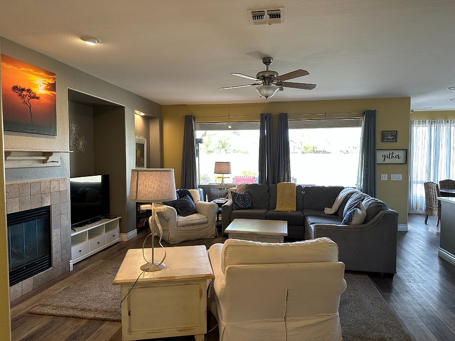 Open Concept Family Room with Video Library, Gas Fireplace, Large View Windows to Patio, Open to Kitchen. (View 2)