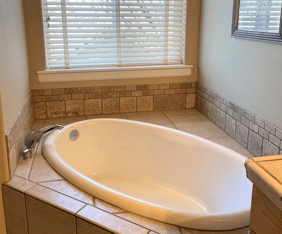 Primary bathroom with shower and window tub, double sinks and a large walk in closet.