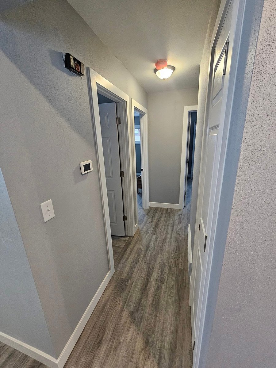 Hallway leading to bathroom and bedrooms.