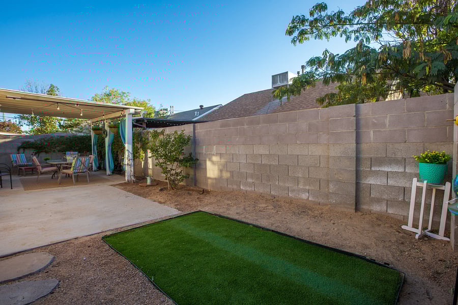 Enjoy the spacious backyard, a versatile outdoor space perfect for relaxation and gatherings. The yard features a cozy shaded patio area, complete with comfortable seating, ideal for enjoying morning coffee or evening conversations. A small patch of artificial turf adds a touch of greenery to the landscape, while potted plants and gentle landscaping provide a charming and low-maintenance setting. This backyard is a great place to soak up some fresh air and unwind during your stay.