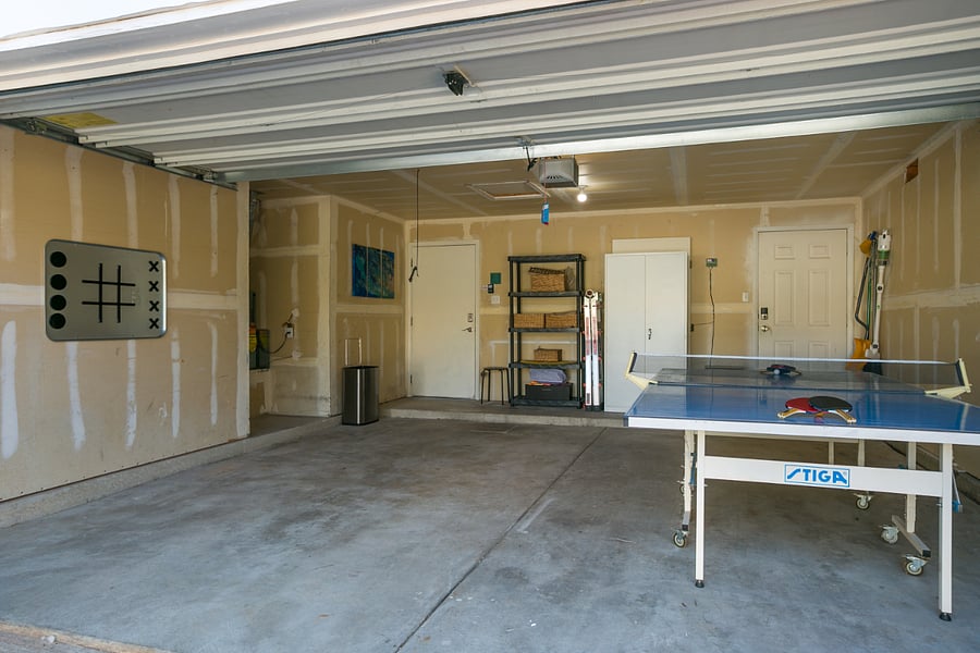 Enjoy a bit of friendly competition in this spacious garage, featuring a ping pong table and a fun wall-mounted tic-tac-toe game, perfect for guests of all ages. This versatile area provides a clean, open space for activities or additional storage during your stay. Equipped with shelving for organized storage and direct access to the house, this garage combines functionality with entertainment, making it a great addition to your stay.