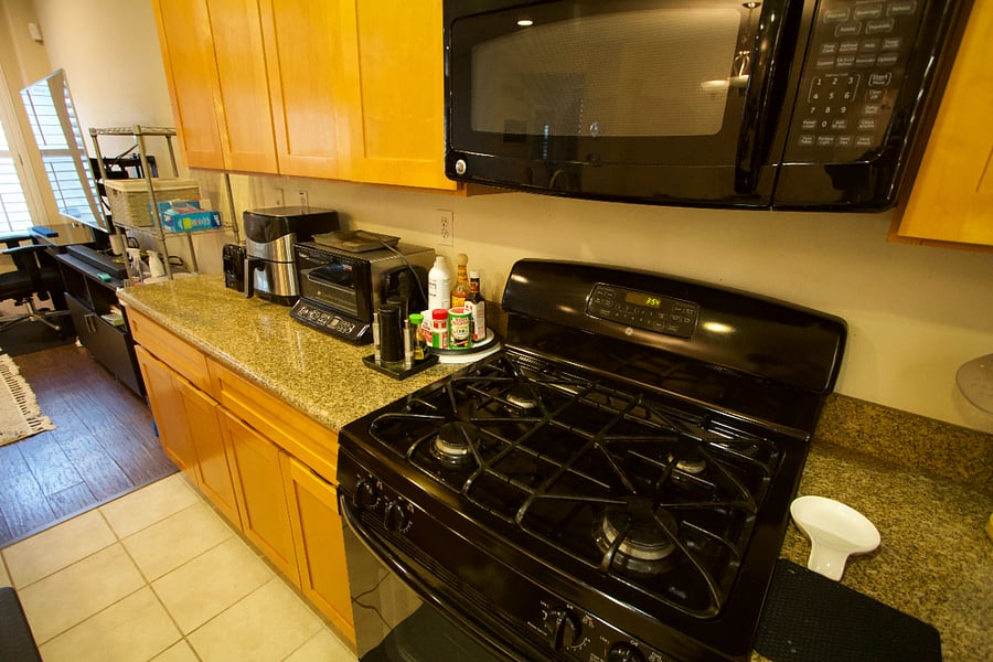 Kitchen equipped with full stove top oven, toaster and air fryer
