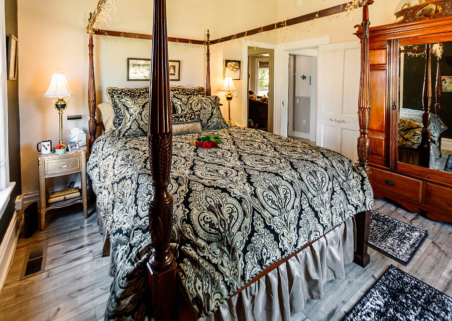 Downstairs large bedroom with pillow top Queen Canopy Bed. Just off the living room and across the hall of the bathroom. Lovely view of the putting green.