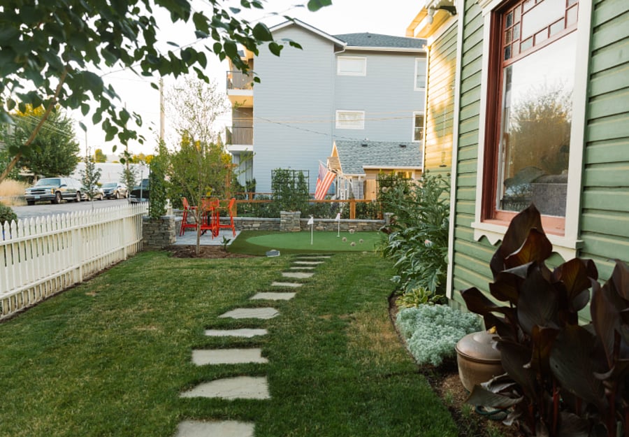 Stepping stones from the front porch to the putting green and bar table with 4 chairs. Great place to wind down and have a snack & beverage.