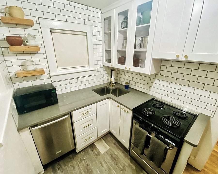 Kitchen with refrigerator, dishwasher, electric range, and microwave.