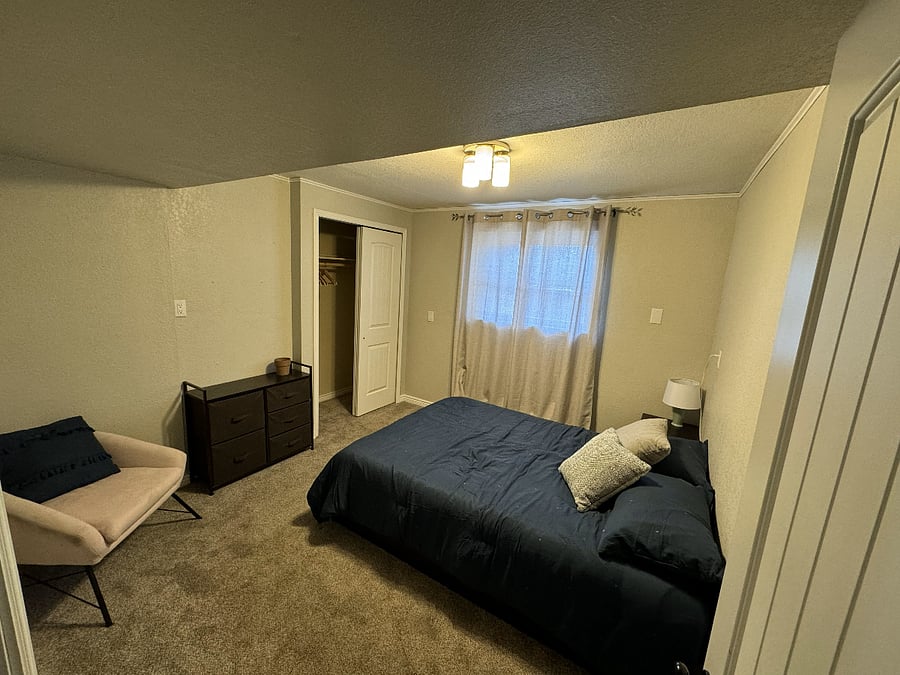 Smaller bedroom with dresser, full mattress (cooling memory foam with mattress protector), closet, nightstand, and chair.